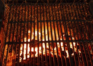 Bar-b-cue grill barbecue with red ashes and sparkles in fire