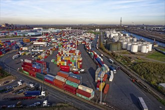 Commercial port with container terminal and oil tanks at the Rhine river in North Rhine-Westphalia,