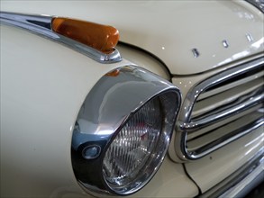 Beige vintage car with chrome headlights and retro accents, doesburg, Netherlands