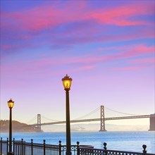 San Francisco Bay bridge from pier 7 in California sunset USA