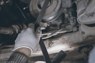 Hands of car mechanic in auto repair service