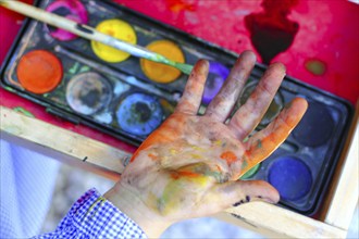 Artist children painting watercolor brush self dirty hands