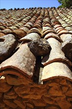 Clay roof tiles old aged arabic style in Spain perspective