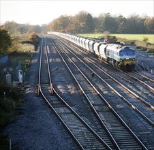 Diesel locomotive freight train on the West Coast mainline at Woodborough, Wiltshire, England, UK