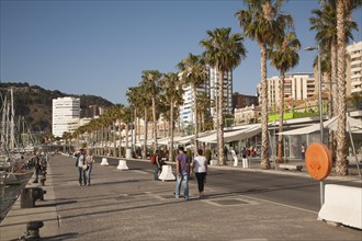 People walking in the newly redeveloped port area of shops and bars Malaga, Spain, Muelle dos,