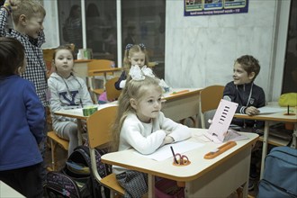 Pupils in a classroom in one of the metro schools in Kharkiv. Classrooms were set up in various