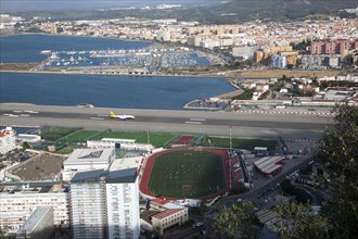 View over airport runway to Spanish town of La Linea from Gibraltar, British overseas territory in