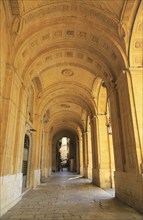 Arched stone passageway gallery National Library building, Valletta, Malta, Europe