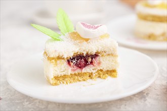 Decorated cake with milk and coconut cream with cup of coffee on a gray concrete background and