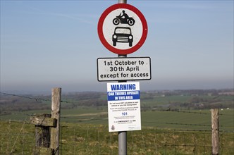 Road signs and car thieves warning sign, Ridgeway at Hackpen Hill, Wiltshire, England, UK