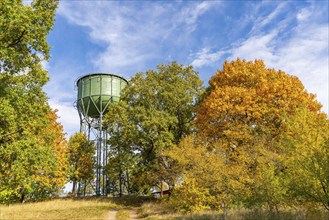 Historic water tower and trees with autumn foliage, Wiesenburg, International Art Trail, Hoher