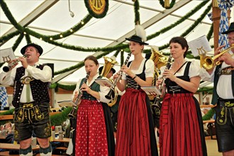 Musicians of a Bavarian brass band in traditional traditional costume playing the clarinet, old