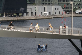 Cyclists on the Lille Langebro cycle and pedestrian bridge over the harbour, Copenhagen is