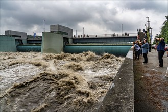 Weir of the Lake Baldeney in Essen, the masses of water roar through the open weirs, high water on