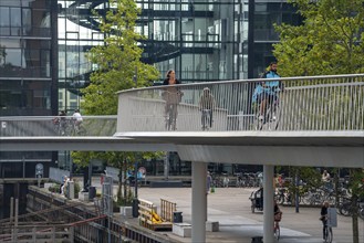 Cyclists on the Cykelslangen cycle and pedestrian bridge, at the Fisketorvet shopping centre,