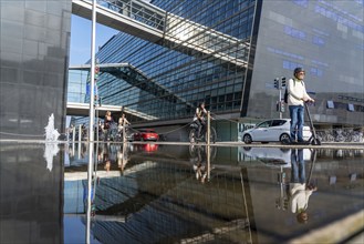 Cyclists on the cycle path on Christians Brygge Street, at the Black Diamond, Danish Royal Library,