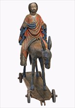 Palm tree donkey around 1380, wooden figure on a dark background, Hohenzollerisches Landesmuseum,