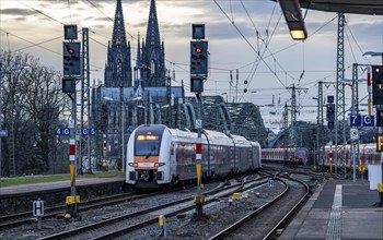 RRX train on the track in front of Cologne Central Station, Hohenzollern Bridge, Cologne Cathedral,