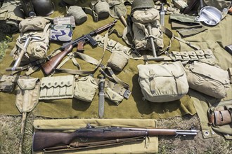 WW2 US soldier outfit and weapons displayed on the ground at World War Two militaria fair showing