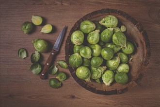 Fresh Brussels sprouts, raw, top view, on a wooden table, no people