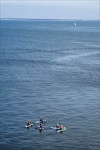 People on paddleboards, White Cliffs. Old Harry Rocks Jurassic Coast, Dorset Coast, Poole, England,