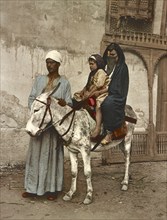 Cairo. Arab woman and her jackass child, Egypt, digitally restored reproduction from a 19th century