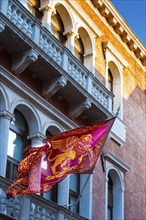 House facade and city flag with the lion of Venice, old building, city trip, holiday, travel,