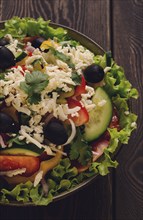 Traditional Bulgarian dish, Shopska salad, on a wooden table, salad of fresh vegetables, top view,