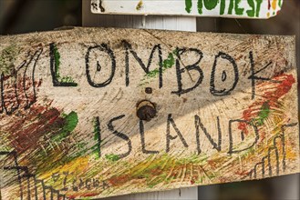 Wooden sign, hand-lettered, holiday, travel, exotic, tourism, handmade, Asian, Lombok, Indonesia,