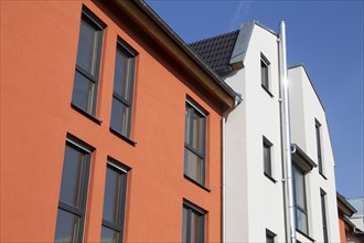 Apartment block with beautiful façade painting in white and Mediterranean orange tone