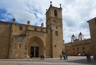 Large square with Gothic church and historic buildings under a blue sky, Cathedral, Concathedral,