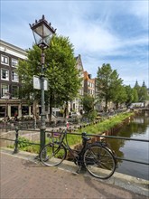 Bicycle on a bridge over Oudezijds Voorburgwal canal, De Wallen, Amsterdam, Netherlands