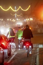 Cyclist, darkness, inner city traffic, Rüttenscheider Straße, bicycle lane, fog, autumn, winter,