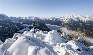 Mountaineers on the snowy summit of the Jenner in autumn, view of the sea of clouds and the