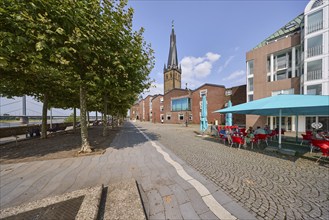 St. Lambert's Basilica with restaurants and riverside promenade with Platanus × acerifolia trees