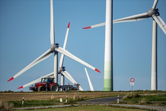 Wind farm near Lichtenau, wind turbines, country road, Driburger Straße, tractor at work in the