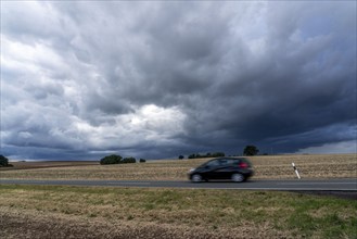 Country road near Waldeck in northern Hesse, thunderstorm front approaching, Germany, Europe