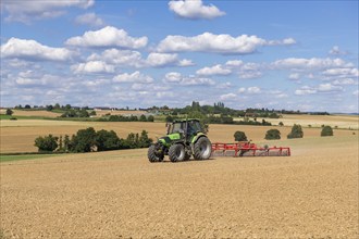 Farmer tilling a field, tractor, ploughing, clouds, Baden-Württemberg, Germany, Europe