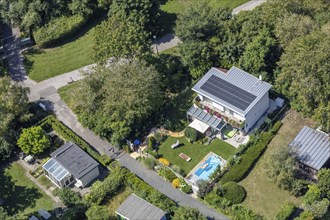 Aerial view of a modern house with garden, pool and solar panels on the roof, Vienna