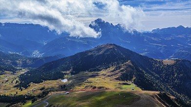 Summit of the Picberg, in the background the peaks of the Sassolungo group, shrouded in fog, drone