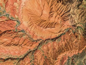 Eroded mountain landscape, top-down, canyon with red and orange rock formations, aerial view,