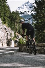 Road bike rider in spring between Lechtal and Tannheimer Tal in front of picturesque scenery of the