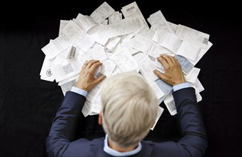 The subject of taxes. A man holds receipts in his hand in Berlin, 09/08/2024