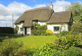 Pretty thatched country cottage and garden, Cherhill, Wiltshire, England, UK, property released