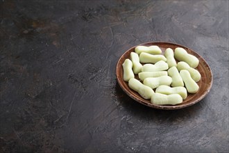 Jelly celery candies on black concrete background. copy space, side view, close up