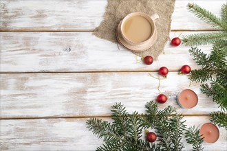 Christmas or New Year composition. Decorations, red balls, fir and spruce branches, cup of coffee,