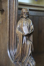 Carved wooden pew end figure, Huntingfield church, Suffolk, England, UK