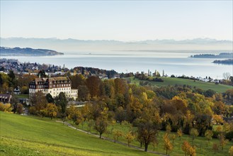 View over Lake Constance in autumn, Spetzgart Castle in front, Alpine chain behind, near