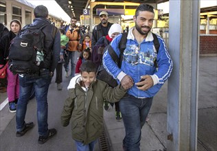 Syrian refugees arrive at Schönefeld station on a special train. They are then taken by bus to