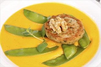 Vegetarian cuisine, walnut cakes on sugar snap peas with pumpkin sauce, sauce, vegetables, snow